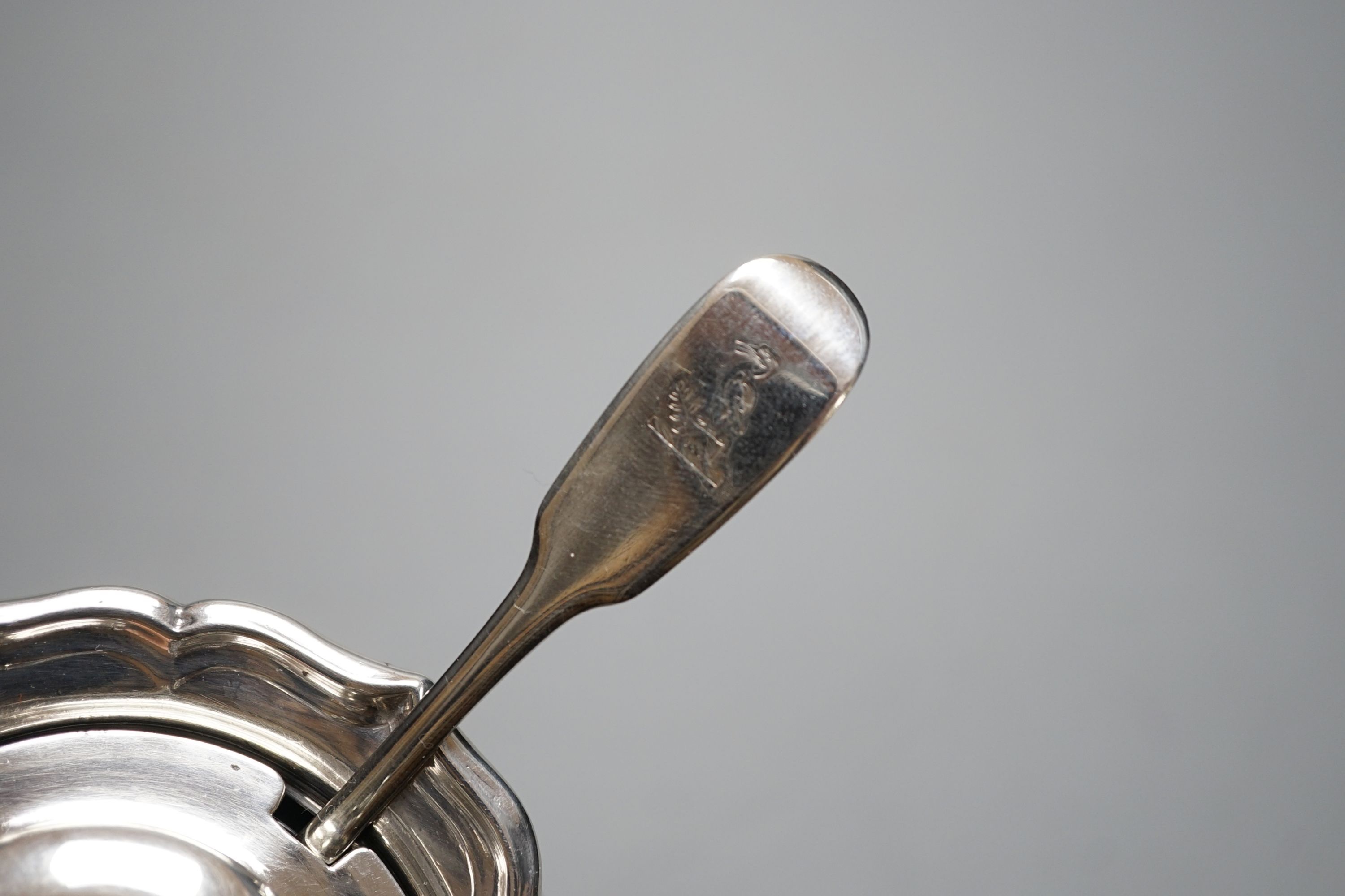 A late William IV silver circular mustard pot, with blue glass liner, The Barnards, London, 1837, with earlier associated fiddle pattern mustard spoon.